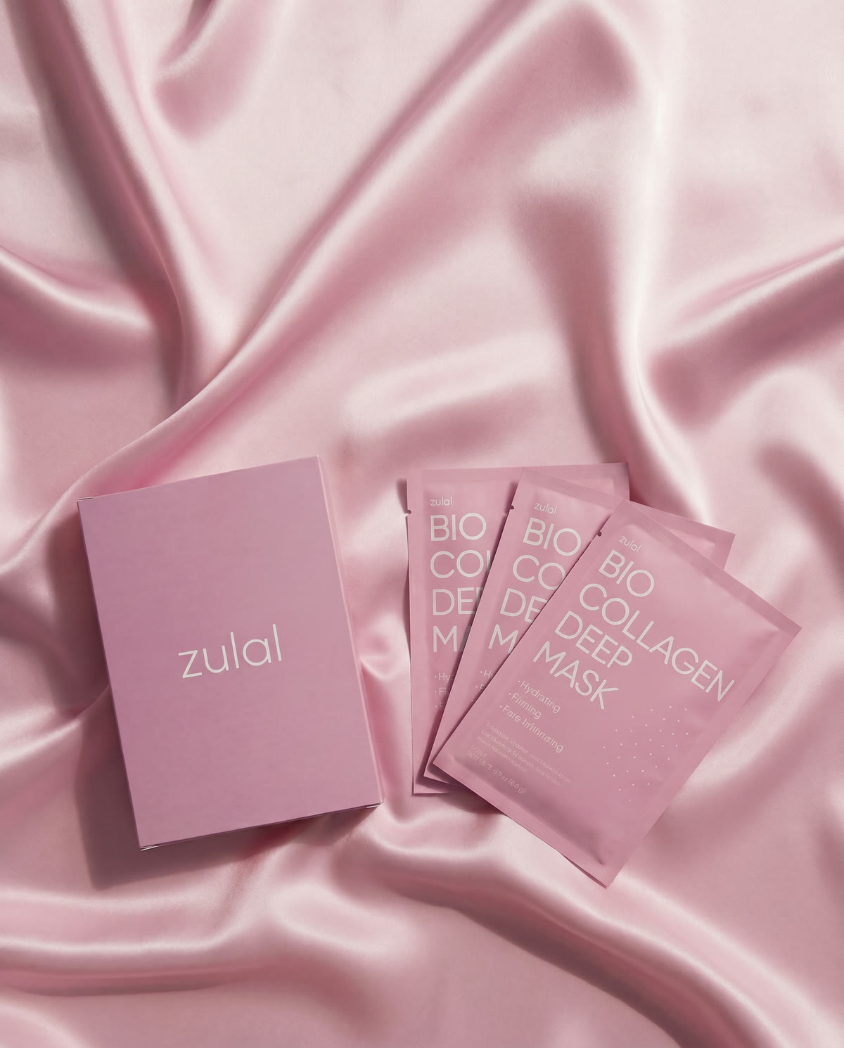 the zulal glow kit — box and mask pouches on rose silk